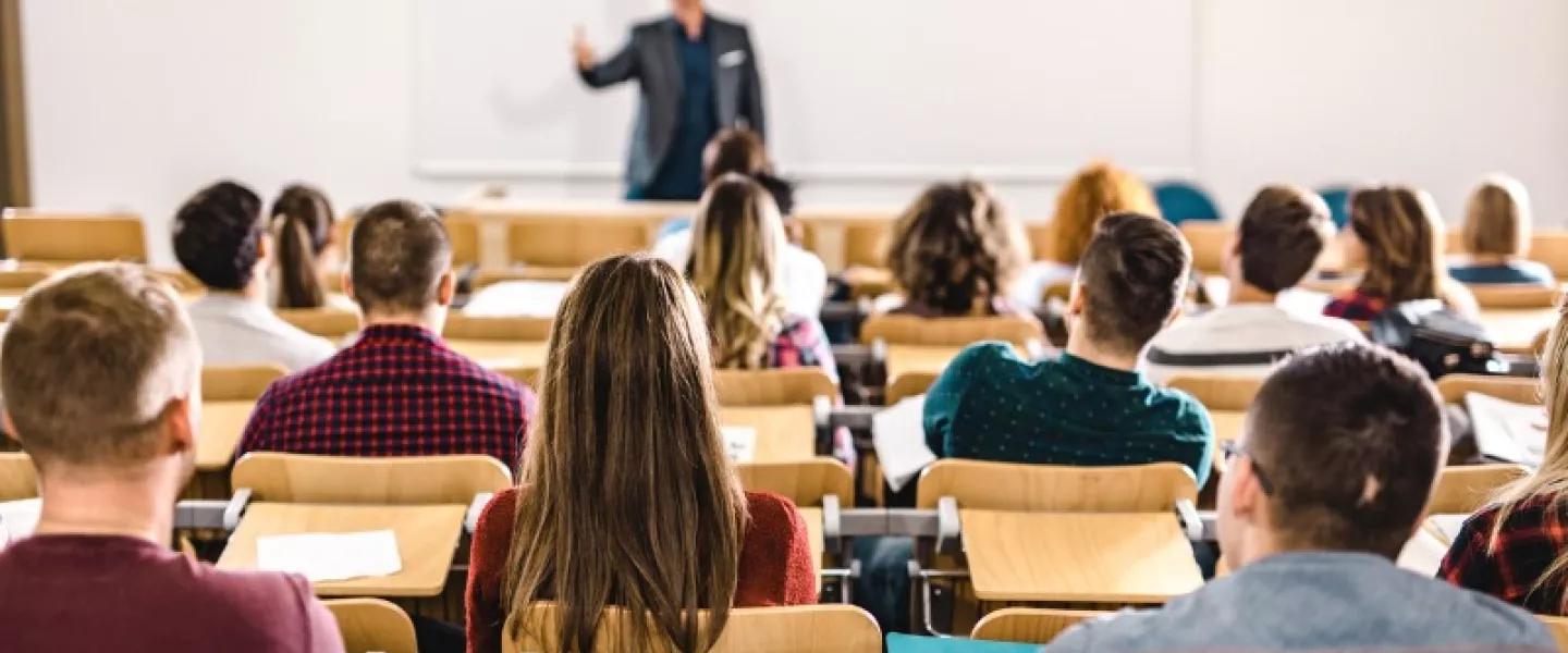 rear-view-of-large-group-of-students-on-a-class-at-lecture-hall-picture-id1069239598.jpg